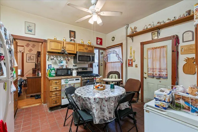 a view of a dining room with furniture and chandelier
