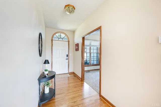 a living room with furniture a fireplace and a large window