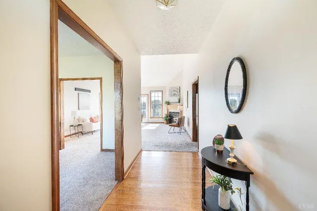 a view of a hallway with wooden floor and closet