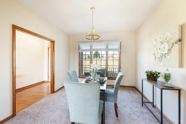 an empty room with windows and ceiling fan