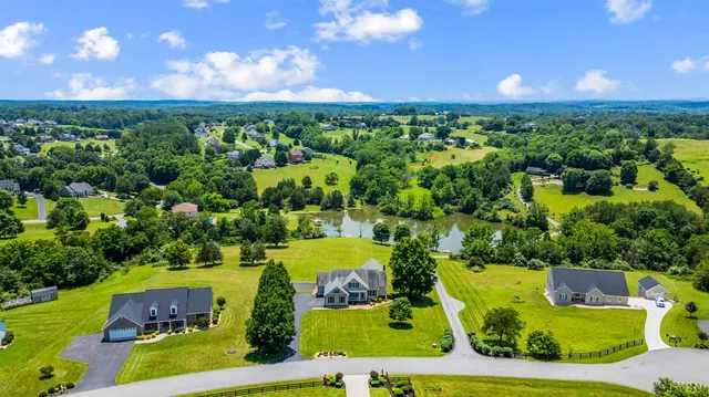 a front view of a house with swimming pool having outdoor seating