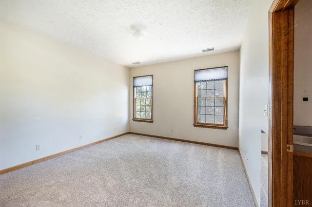 a kitchen with granite countertop a sink and a white wooden cabinets