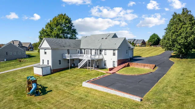 a view of a hallway with wooden floor and entryway