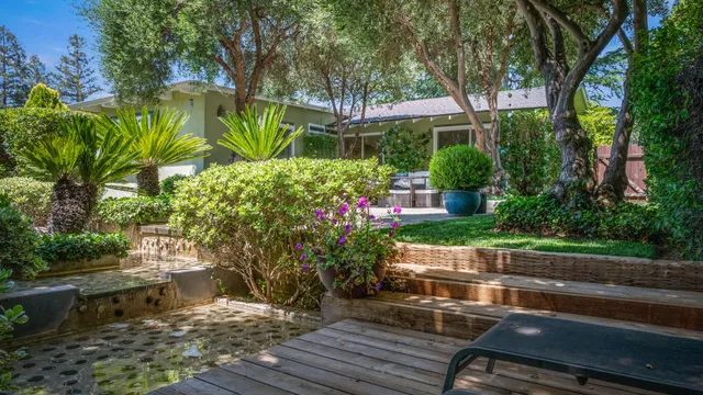 a view of yard with seating area and trees around