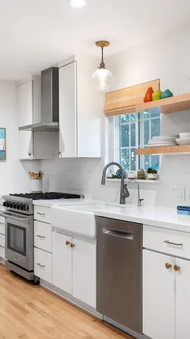 a kitchen with stainless steel appliances granite countertop a sink and a stove