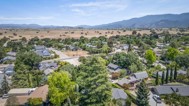 an aerial view of a city and mountain view in back