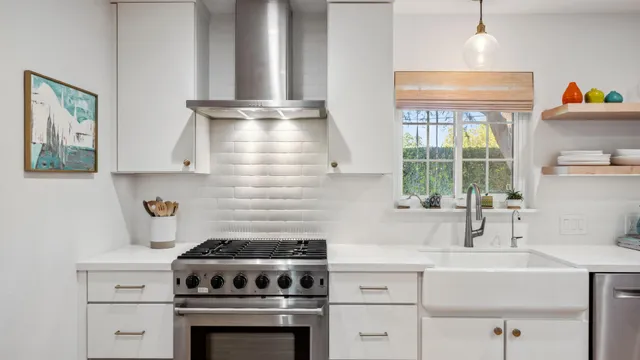 a kitchen with stainless steel appliances a stove and a sink
