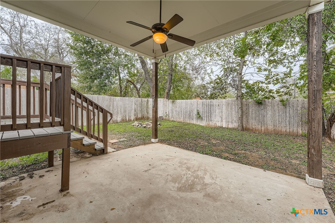 304 South Main Street Elgin, TX 78621 - Photo 23 of 25 Fenced backyard with a patio and ceiling fan