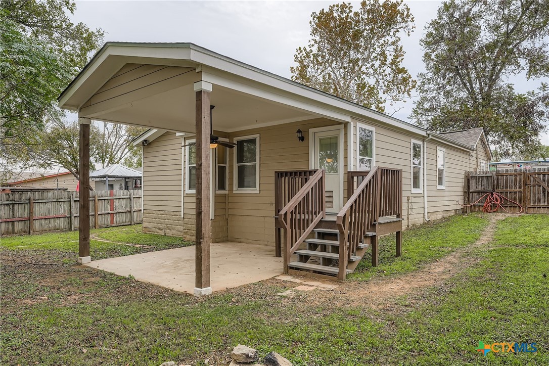 304 South Main Street Elgin, TX 78621 - Photo 25 of 25 Rear view of property with a patio and a fenced backyard