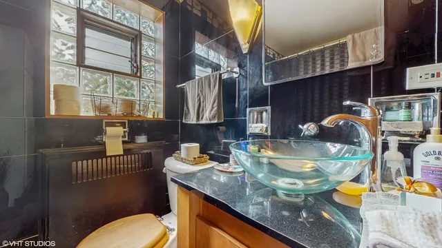 a kitchen with a sink a stove and a dining table with garden view