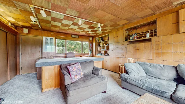 a living room with furniture and a floor to ceiling window