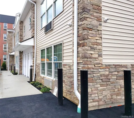 a view of a brick house with a large windows