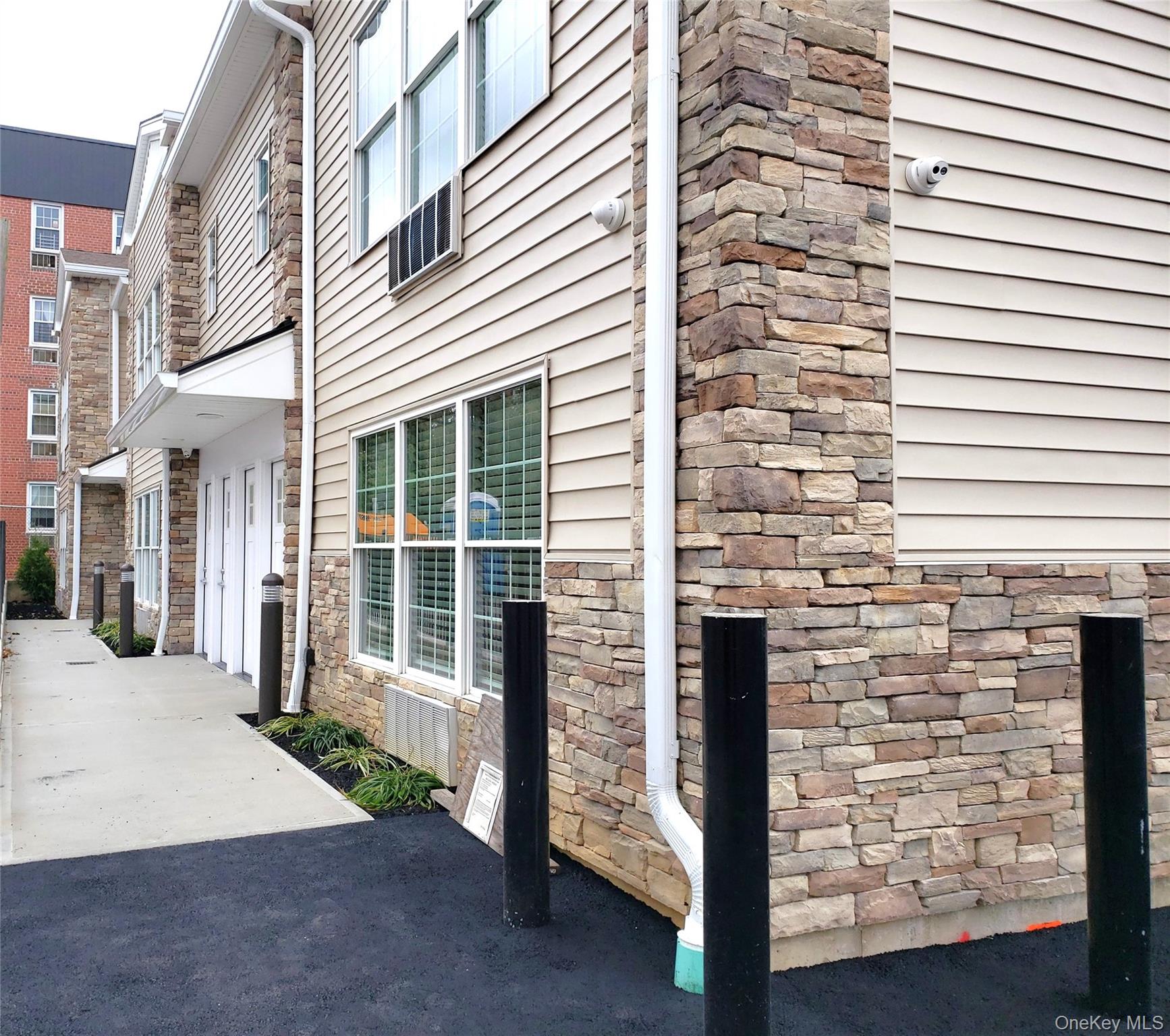 a view of a brick house with a large windows