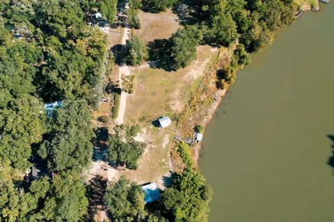 an aerial view of residential building and lake