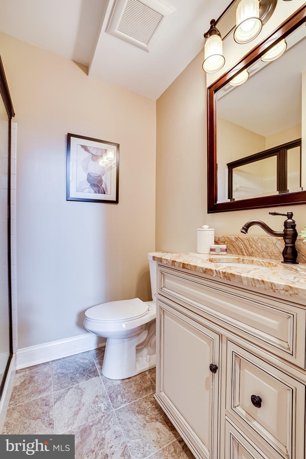 11056 Thrush Ridge Road Reston, VA 20191 - Photo 42 of 62 a bathroom with a toilet sink and mirror