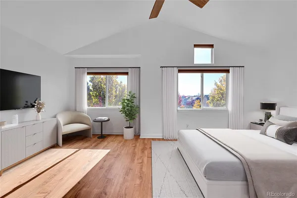 a bedroom with a bed and a large window
