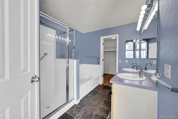 a en suite bathroom with a sink double vanity and a mirror