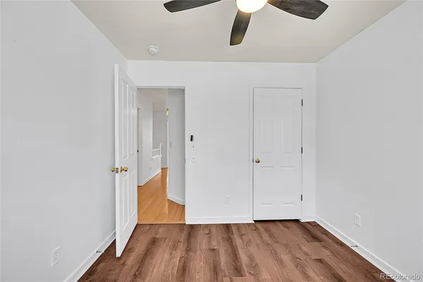 a view of an empty room with wooden floor