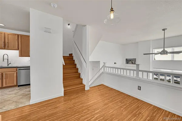 a view of entryway and hall with wooden floor