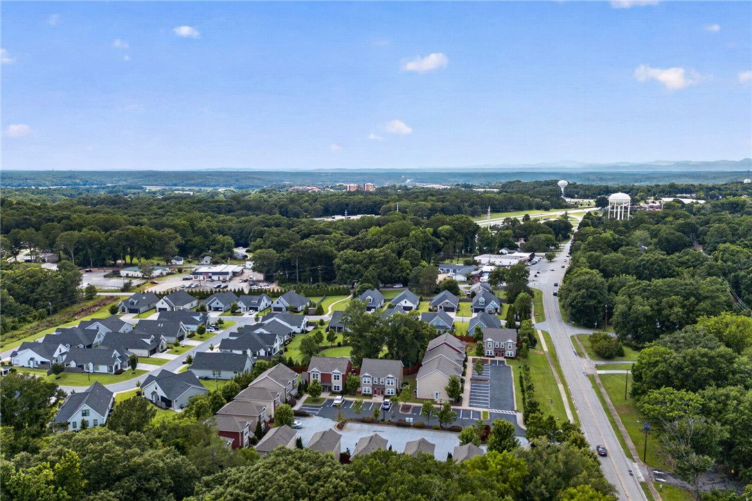 235 Pendleton Road, Unit K1 Clemson, SC 29631 - Photo 45 of 49 An aerial panorama reveals a harmonious blend of suburban residences, lush woodlands, and distant cityscapes.