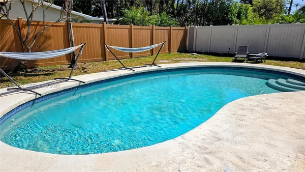 a view of swimming pool with a lounge chair