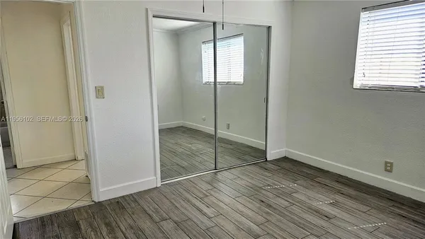 a view of an empty room with glass door