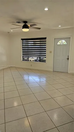 a view of a livingroom with an empty space and a window