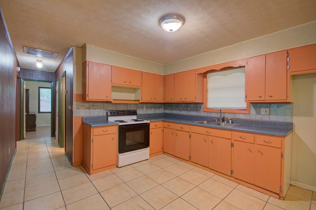 92 No-Where Road Blairsville, GA 30512 - Photo 4 of 36 a large kitchen with granite countertop a sink and white cabinets