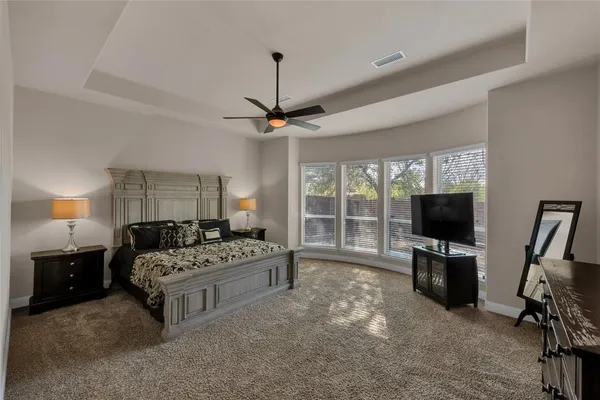 a bedroom with a bed and glass door