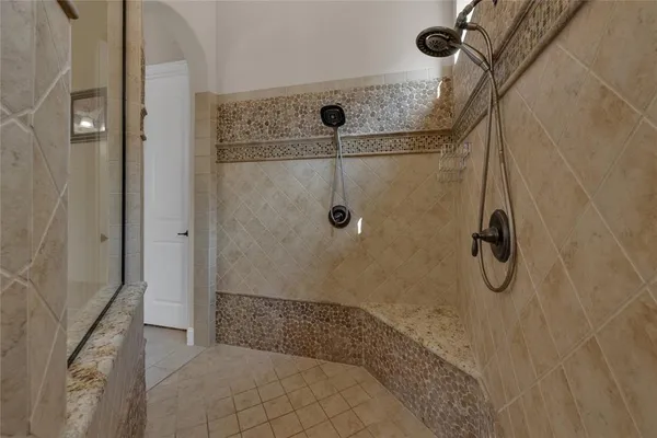 a bathroom with a glass shower door
