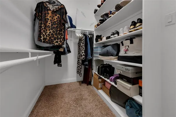 walk in closet with white walls