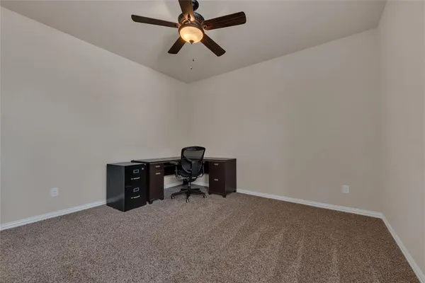 a view of room with workspace and a window