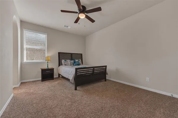 a bedroom with a bed and window