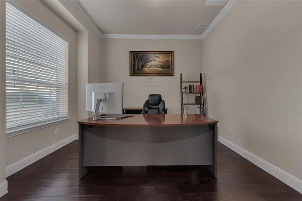 a view of a workspace with furniture and window