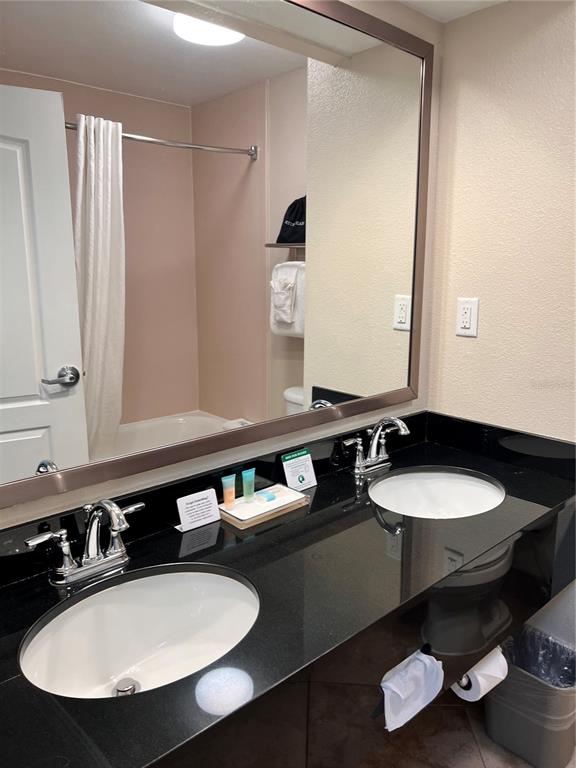 3000 Maingate Lane, Unit 506 Kissimmee, FL 34747 - Photo 6 of 18 a bathroom with a sink and a mirror