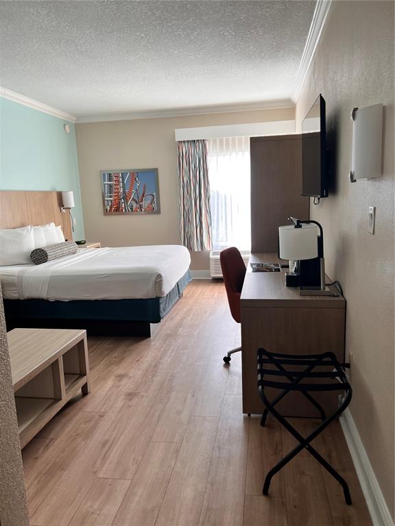 3000 Maingate Lane, Unit 506 Kissimmee, FL 34747 - Photo 7 of 18 a bedroom with a bed and a flat screen tv