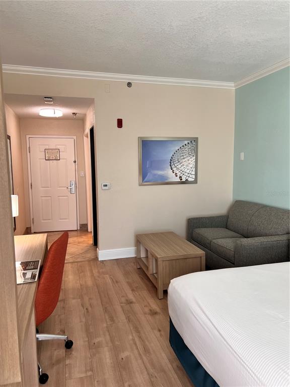 3000 Maingate Lane, Unit 506 Kissimmee, FL 34747 - Photo 8 of 18 a bedroom with two beds and painting on the wall