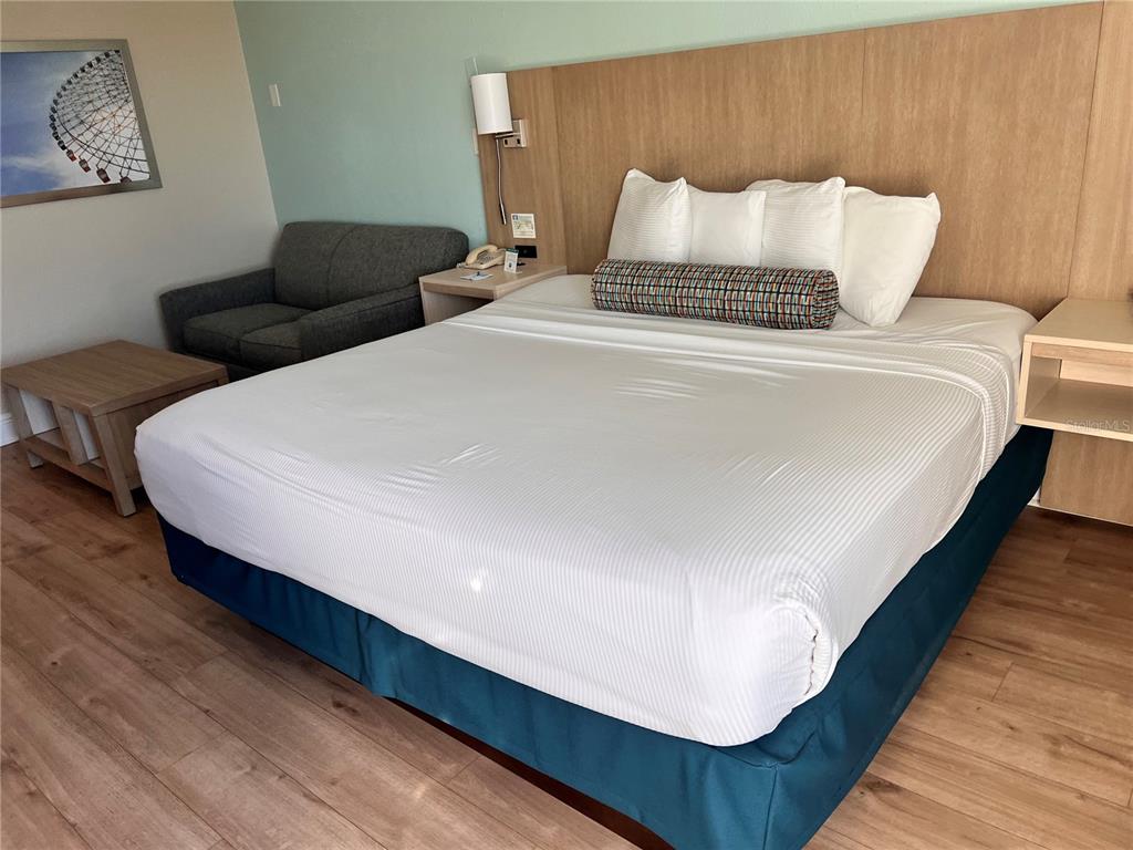 3000 Maingate Lane, Unit 506 Kissimmee, FL 34747 - Photo 10 of 18 a bed sitting in a bedroom and with a night stand