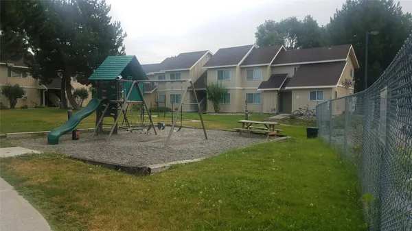 a view of multiple houses with a yard