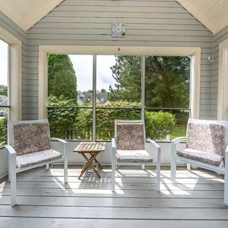 4 Red Cedar Road, Unit 4 Mashpee, MA 02649 - Photo 11 of 25 a living room with large windows and a table