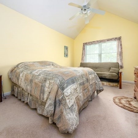4 Red Cedar Road, Unit 4 Mashpee, MA 02649 - Photo 14 of 25 a bedroom with a bed and a couch