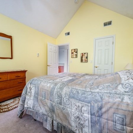4 Red Cedar Road, Unit 4 Mashpee, MA 02649 - Photo 15 of 25 a bedroom with a bed and a dresser