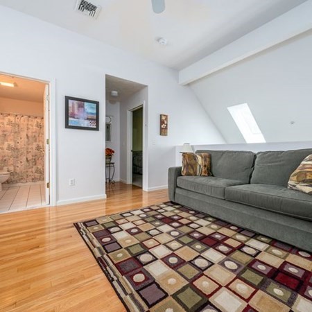 4 Red Cedar Road, Unit 4 Mashpee, MA 02649 - Photo 17 of 25 a living room with a couch and a wooden floor