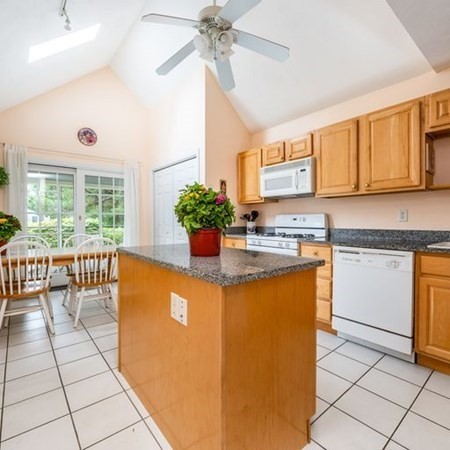 4 Red Cedar Road, Unit 4 Mashpee, MA 02649 - Photo 8 of 25 a kitchen with stainless steel appliances granite countertop a sink and cabinets