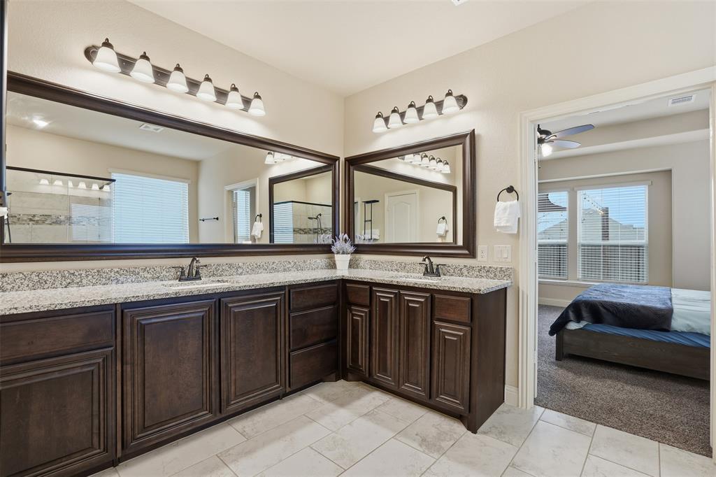 4002 Grove Valley Road Midlothian, TX 76065 - Photo 20 of 40 a spacious bathroom with a granite countertop double vanity and a mirror