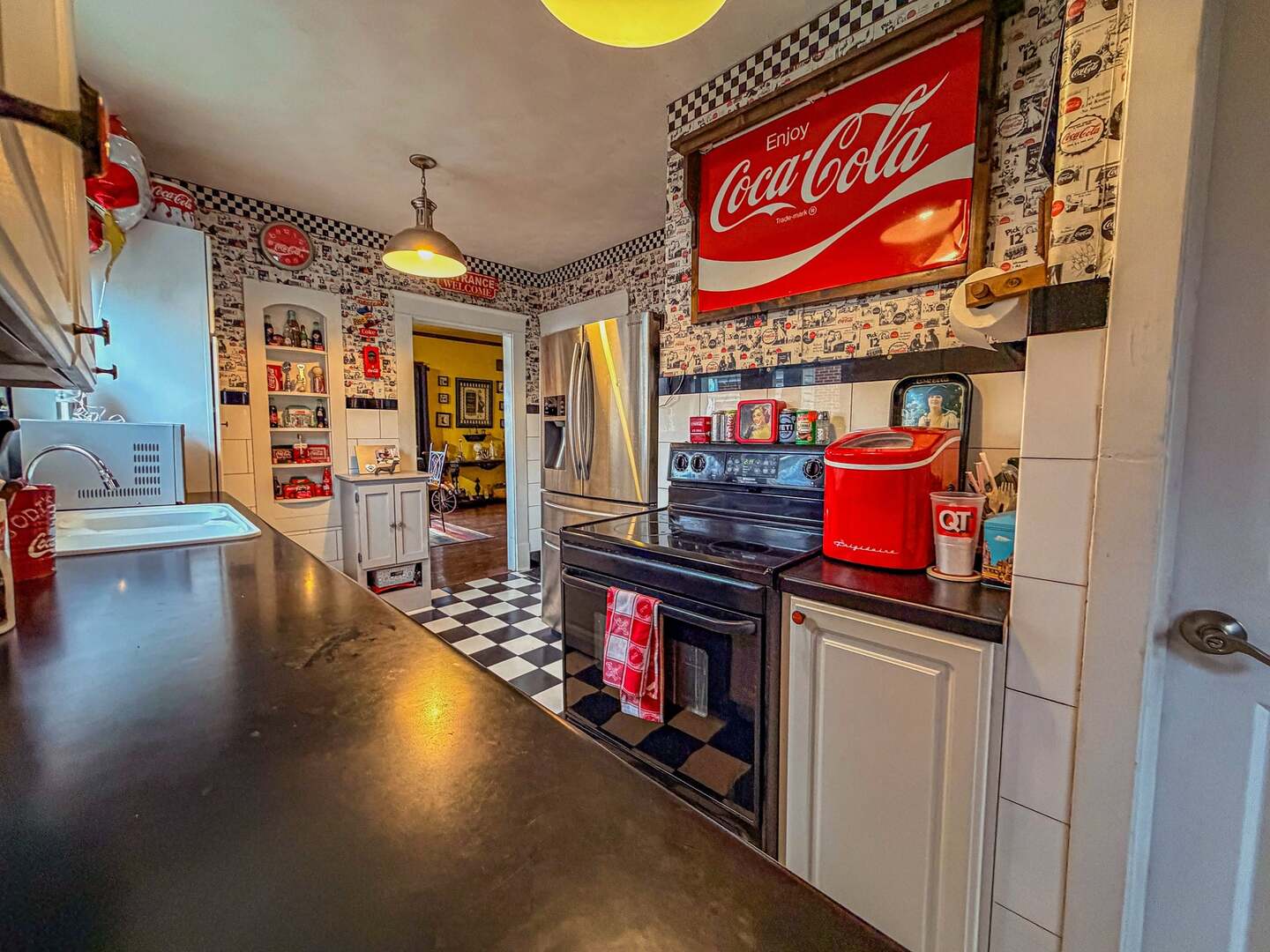 433 East Main Street Salem, IL 62881 - Photo 10 of 48 a store room with stainless steel appliances kitchen island granite countertop a table and chairs in it