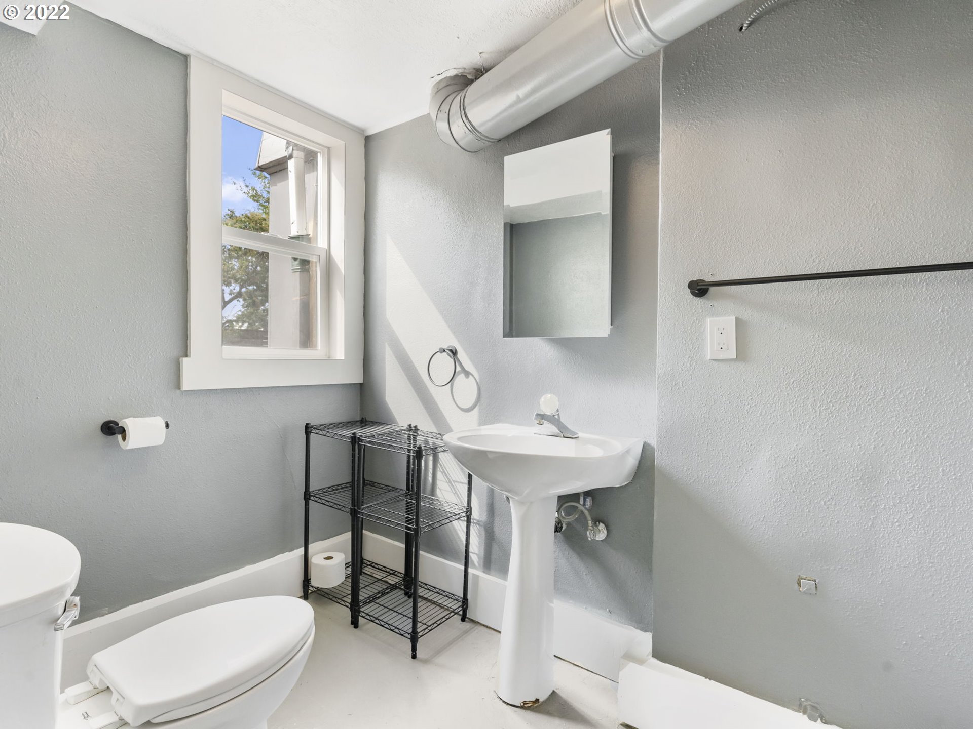 7320 Southwest Canyon Lane Portland, OR 97225 - Photo 28 of 32 a bathroom with a sink a toilet and a mirror