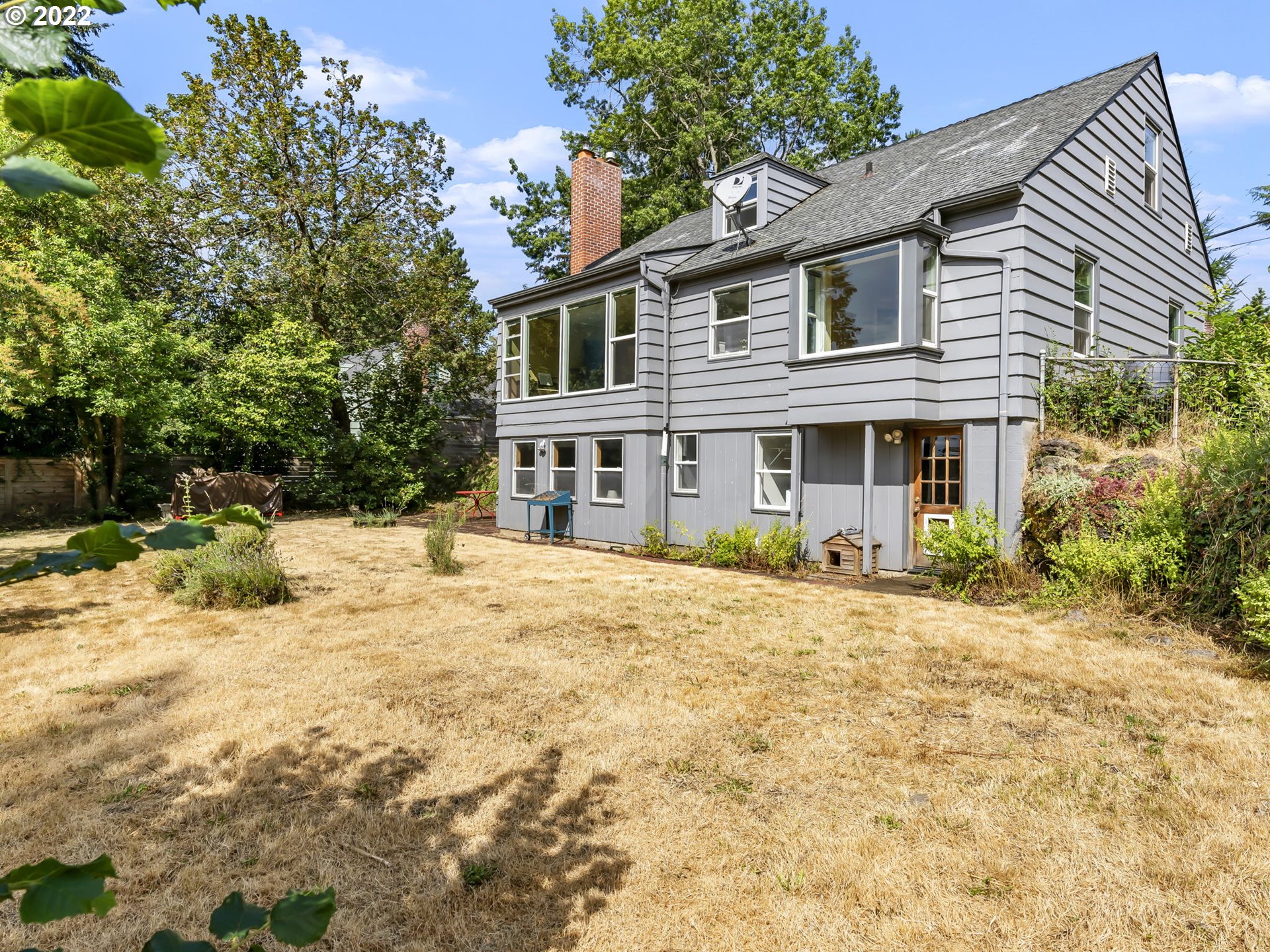7320 Southwest Canyon Lane Portland, OR 97225 - Photo 30 of 32 a front view of a house with a yard covered with trees