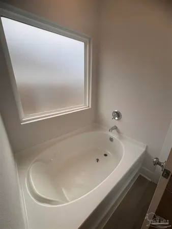 a white bath tub sitting next to a white sink