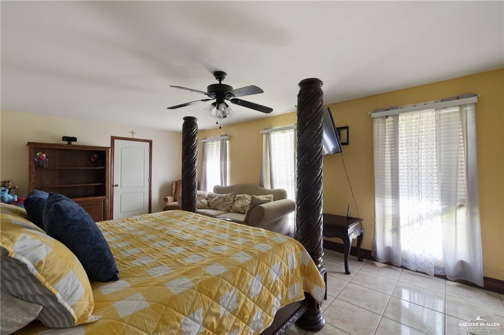 4523 South Tower Road Edinburg, TX 78542 - Photo 27 of 32 a bedroom with a bed and a chandelier